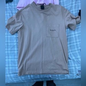 brown plain shirt with pocket saying  “New York”